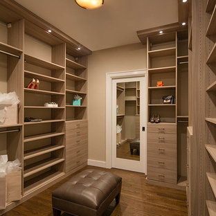Example of a transitional gender-neutral dark wood floor and brown floor dressing room design in San Francisco with flat-panel cabinets and light wood cabinets