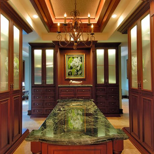 Modelo de vestidor exótico con puertas de armario de madera en tonos medios y armarios con paneles con relieve