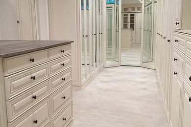 Walk-in closet - transitional gender-neutral walk-in closet idea in Miami with beaded inset cabinets and white cabinets