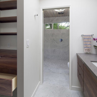 Foto di un piccolo spazio per vestirsi unisex minimalista con ante lisce, ante in legno scuro, pavimento in marmo e pavimento multicolore