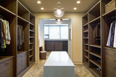 Closet - contemporary closet idea in Calgary with dark wood cabinets