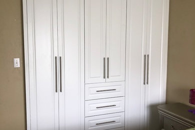 Closet - modern closet idea in Toronto with white cabinets