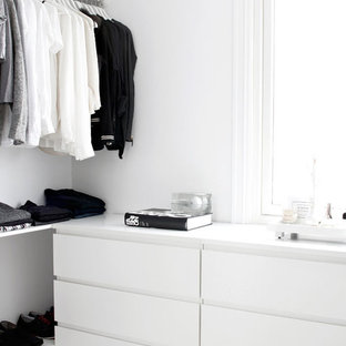 Foto de armario unisex, moderno, pequeño, con armarios con paneles lisos, puertas de armario blancas y suelo blanco