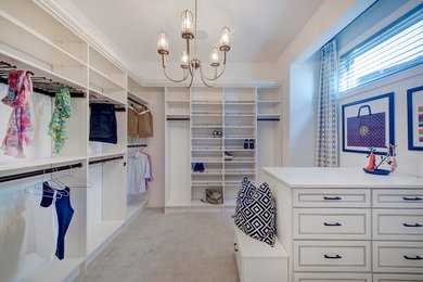 Large trendy women's carpeted walk-in closet photo in Calgary with recessed-panel cabinets and white cabinets