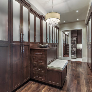 Dressing room - huge contemporary gender-neutral medium tone wood floor and brown floor dressing room idea in Other with flat-panel cabinets and dark wood cabinets