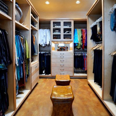 Example of a large classic women's concrete floor dressing room design in Dallas with flat-panel cabinets and light wood cabinets