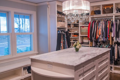 Example of a large gender-neutral walk-in closet design in Providence
