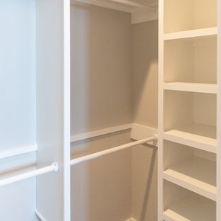 Walk-in closet - small cottage gender-neutral dark wood floor and brown floor walk-in closet idea in Austin with open cabinets and white cabinets