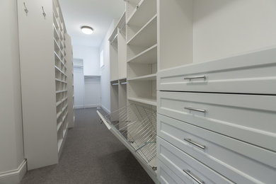 Walk-in closet - large gender-neutral carpeted and gray floor walk-in closet idea in Minneapolis with recessed-panel cabinets and white cabinets