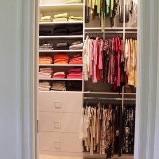 Bild på ett mellanstort funkis walk-in-closet för kvinnor, med släta luckor, vita skåp och klinkergolv i porslin