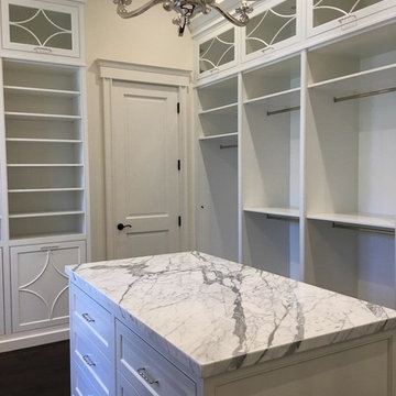 Solid Wood White Painted Master Closet with Glass Doors and In Cabinet Lighting