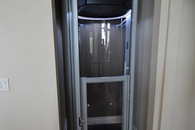 Example of a small classic dark wood floor and brown floor closet design in Austin