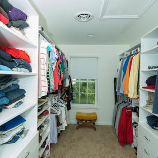 Mid-sized elegant gender-neutral carpeted walk-in closet photo in Philadelphia with flat-panel cabinets and white cabinets