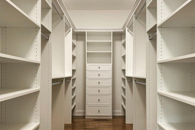 Inspiration for a large contemporary gender-neutral walk-in closet remodel in New York with shaker cabinets and white cabinets