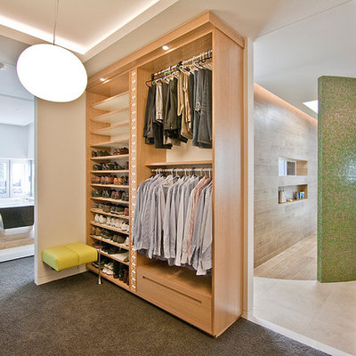 Inspiration for a contemporary men's carpeted dressing room remodel in Los Angeles with open cabinets and light wood cabinets