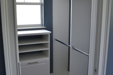 Ejemplo de armario vestidor unisex contemporáneo con puertas de armario blancas y armarios con paneles con relieve