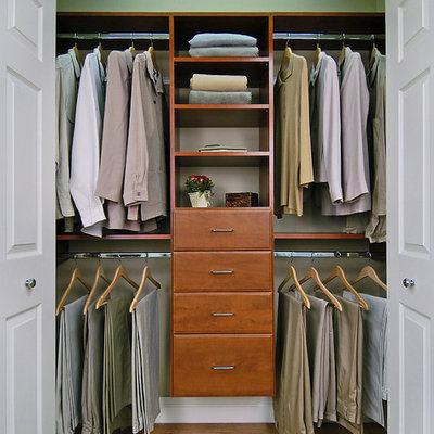 Example of a mid-sized classic gender-neutral brown floor and laminate floor reach-in closet design in Burlington with open cabinets