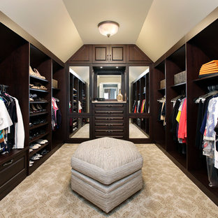 Inspiration for a timeless walk-in closet remodel in Chicago with dark wood cabinets