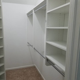 Walk-in closet - mid-sized traditional gender-neutral carpeted and beige floor walk-in closet idea in Jacksonville with open cabinets and white cabinets
