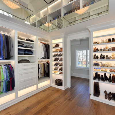 Large transitional gender-neutral medium tone wood floor and brown floor walk-in closet photo in New York with open cabinets and white cabinets