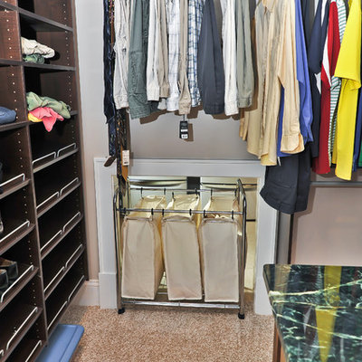 Elegant men's walk-in closet photo in DC Metro with open cabinets and dark wood cabinets