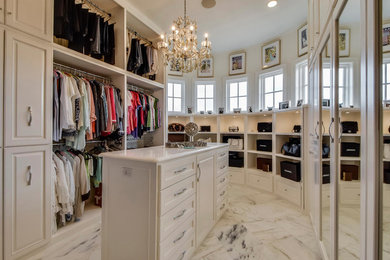 Inspiration for a mediterranean women's marble floor dressing room remodel in Austin with white cabinets