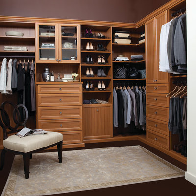 Example of a large classic gender-neutral dark wood floor and brown floor dressing room design in Orlando with open cabinets and medium tone wood cabinets