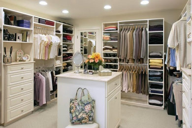 Inspiration for a large timeless gender-neutral carpeted walk-in closet remodel in Boston with raised-panel cabinets and white cabinets