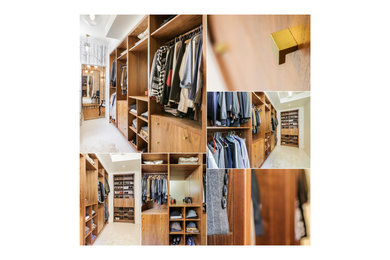 Example of a huge minimalist gender-neutral walk-in closet design in Atlanta with flat-panel cabinets and medium tone wood cabinets