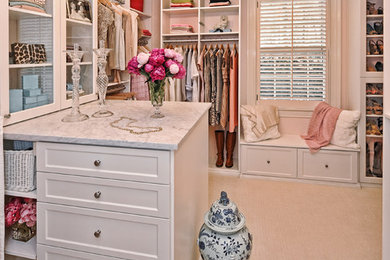 Example of a large classic women's carpeted walk-in closet design in Charlotte with shaker cabinets and white cabinets