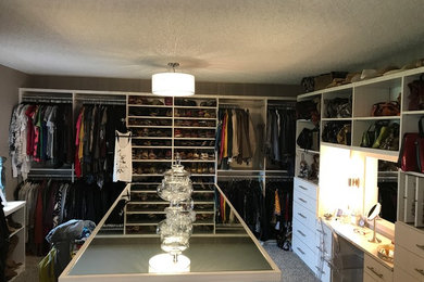 Trendy gender-neutral carpeted and gray floor closet photo in Chicago with flat-panel cabinets and white cabinets