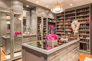 Inspiration for a large transitional women's light wood floor walk-in closet remodel in New York with shaker cabinets and gray cabinets