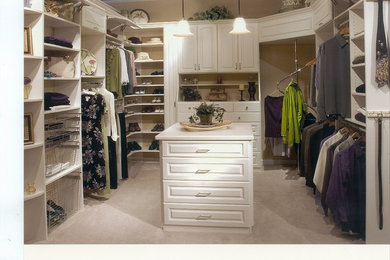 Inspiration for a large timeless gender-neutral carpeted walk-in closet remodel in Atlanta with raised-panel cabinets and white cabinets