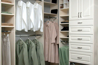 Mid-sized elegant gender-neutral carpeted walk-in closet photo in New York with recessed-panel cabinets and white cabinets
