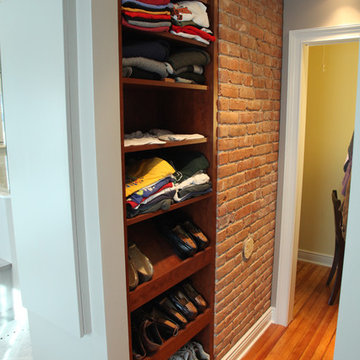 Walk in closet with exposed brick chimney