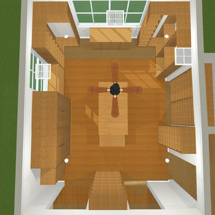 Esempio di una grande cabina armadio unisex moderna con ante lisce, ante in legno scuro e parquet chiaro