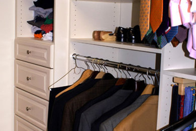 Mid-sized transitional gender-neutral walk-in closet photo in New York with raised-panel cabinets and white cabinets