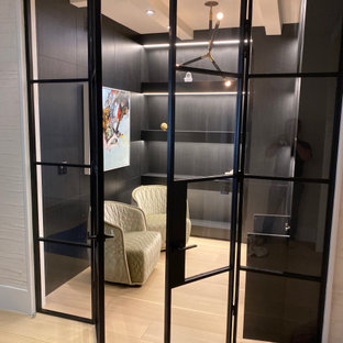 Immagine di grandi armadi e cabine armadio minimalisti con pavimento in laminato