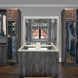 Exempel på ett mellanstort klassiskt walk-in-closet för könsneutrala, med luckor med infälld panel, skåp i slitet trä, mörkt trägolv och brunt golv