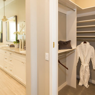 Walk-in closet - gender-neutral carpeted walk-in closet idea in Orange County with flat-panel cabinets and white cabinets