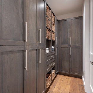 Foto de armario vestidor unisex, minimalista, de tamaño medio, con armarios estilo shaker, puertas de armario marrones, suelo de madera en tonos medios y suelo marrón