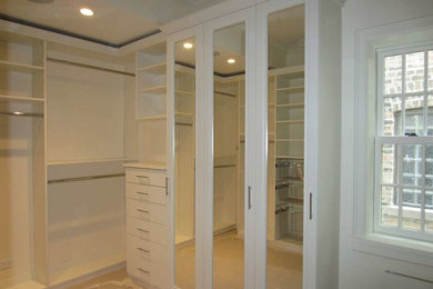 Large elegant women's walk-in closet photo in Chicago with white cabinets