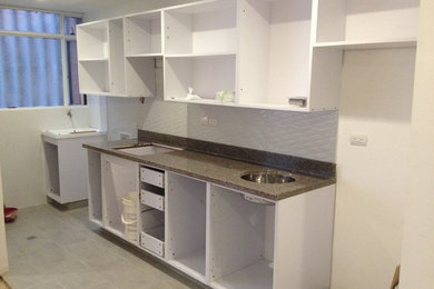 Photo of a small modern single-wall open plan kitchen in Other with porcelain flooring and grey floors.