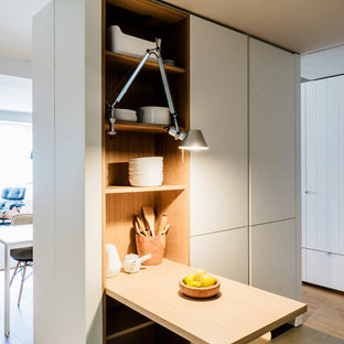 Small scandinavian l-shaped open plan kitchen in Madrid with an undermount sink, flat-panel cabinets, white cabinets, quartz benchtops, white splashback, glass sheet splashback, panelled appliances, ceramic floors and no island.