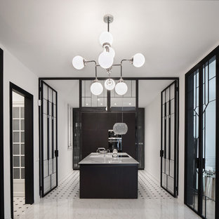Foto de cocina nórdica, grande, cerrada, con armarios con paneles lisos, puertas de armario negras, una isla, suelo multicolor y encimeras blancas