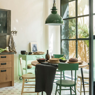 This is an example of a large single-wall separate kitchen in Barcelona with an undermount sink, glass-front cabinets, stainless steel cabinets, marble benchtops, metallic splashback, metal splashback, stainless steel appliances, ceramic floors, with island, multi-coloured floor and beige benchtop.