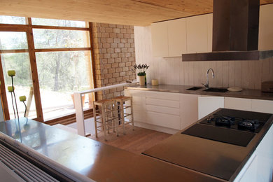 Photo of a large mediterranean u-shaped open plan kitchen in Barcelona with no island.