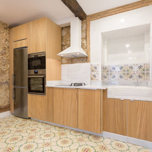 Modelo de cocina lineal, mediterránea, de tamaño medio, sin isla, con puertas de armario de madera oscura, salpicadero de azulejos de cerámica, encimeras blancas, fregadero sobremueble, armarios con paneles lisos, salpicadero multicolor, electrodomésticos de acero inoxidable, suelo de baldosas de cerámica y suelo multicolor