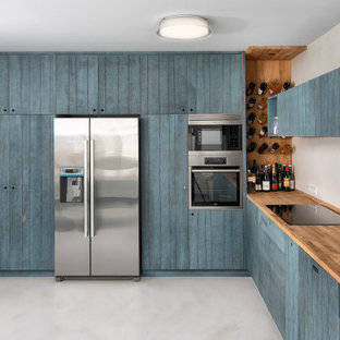 Mid-sized contemporary l-shaped kitchen in Other with an undermount sink, louvered cabinets, turquoise cabinets, wood benchtops, stainless steel appliances, no island, grey floor and beige benchtop.