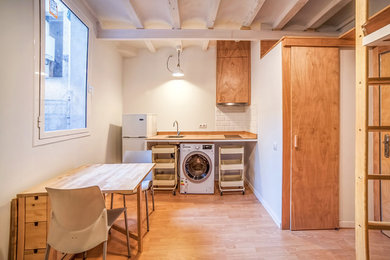 Example of a small farmhouse single-wall eat-in kitchen design in Barcelona with open cabinets and no island